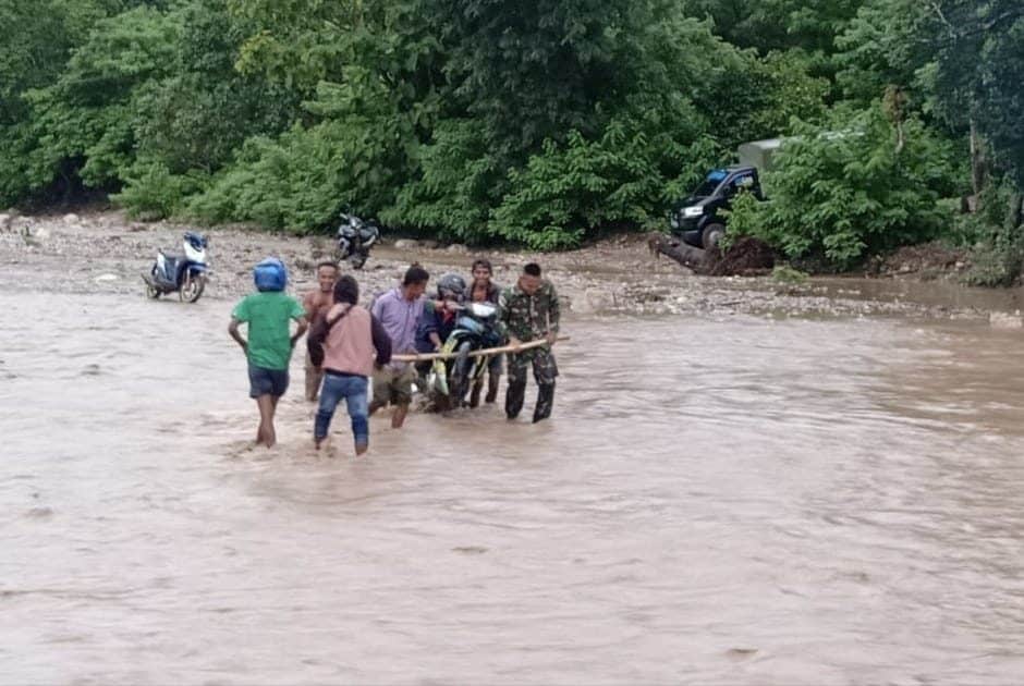 Terjebak Banjir, Satgas Yonif 132 Bantu Warga Seberangkan Kendaraan
