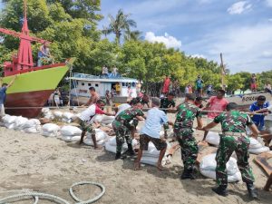 Gotong Royong, Satgas Yonarmed 6/3 Bersama Warga Turunkan Kapal Ke Pantai