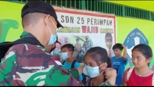 Tekan Penyebaran Covid -19, Satgas Yonif 144/JY Bagikan Masker Kepada Siswa Sekolah Di Perbatasan