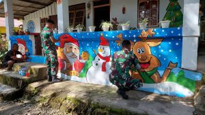 Personel Satgas Yonarhanud 11/WBY Buat Lukisan Mural Bertemakan Natal Di Rumah Warga