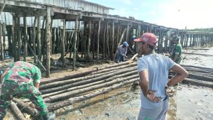 Satgas Kodim Maluku Yonarhanud 11/WBY dan Masyarakat Bergotong Royong Memperbaiki Jalan di Dermaga Desa Mesiang