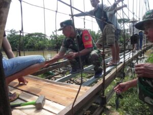 Atasi Kesulitan Warga, Babinsa Koramil 0602-11/Tirtayasa Bantu Perbaiki Jembatan